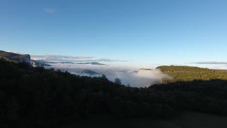 Aerial-drone-shot-flying-towards-Vercors-cloudy-mountains.-Mystic-sunrise.